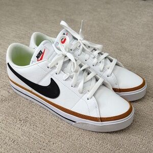 Nike White Low-Top Sneakers with Black Swoosh and Brown Trim